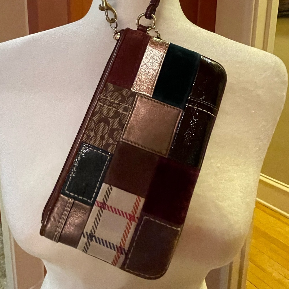 Pre-owned Coach Multi-pattern wristlet.